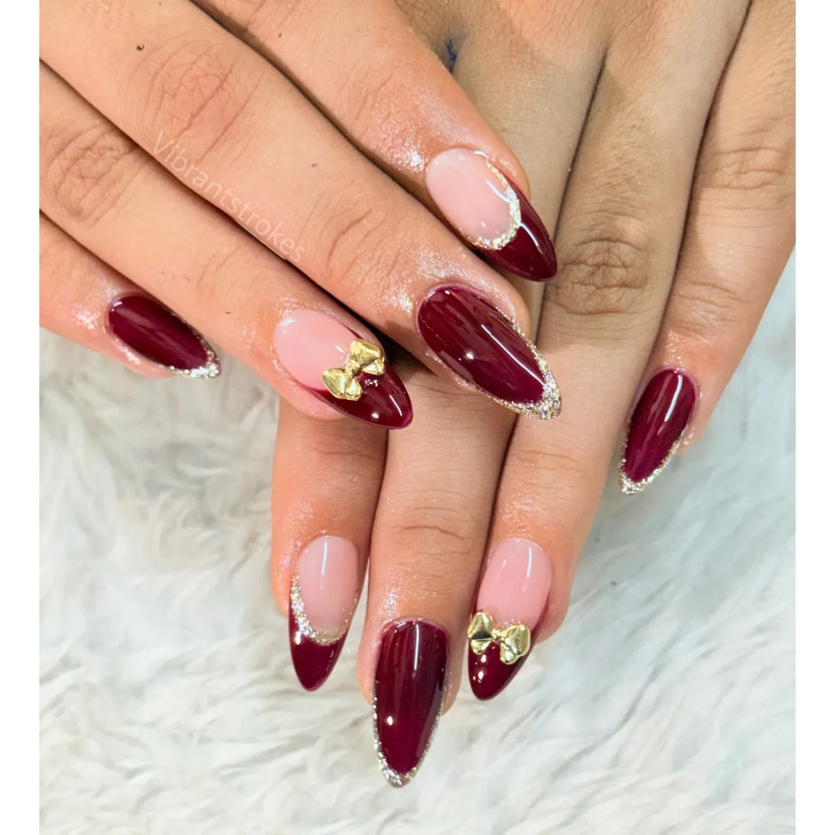 Nude and burgundy almonds with gold glitter edging and bow accents