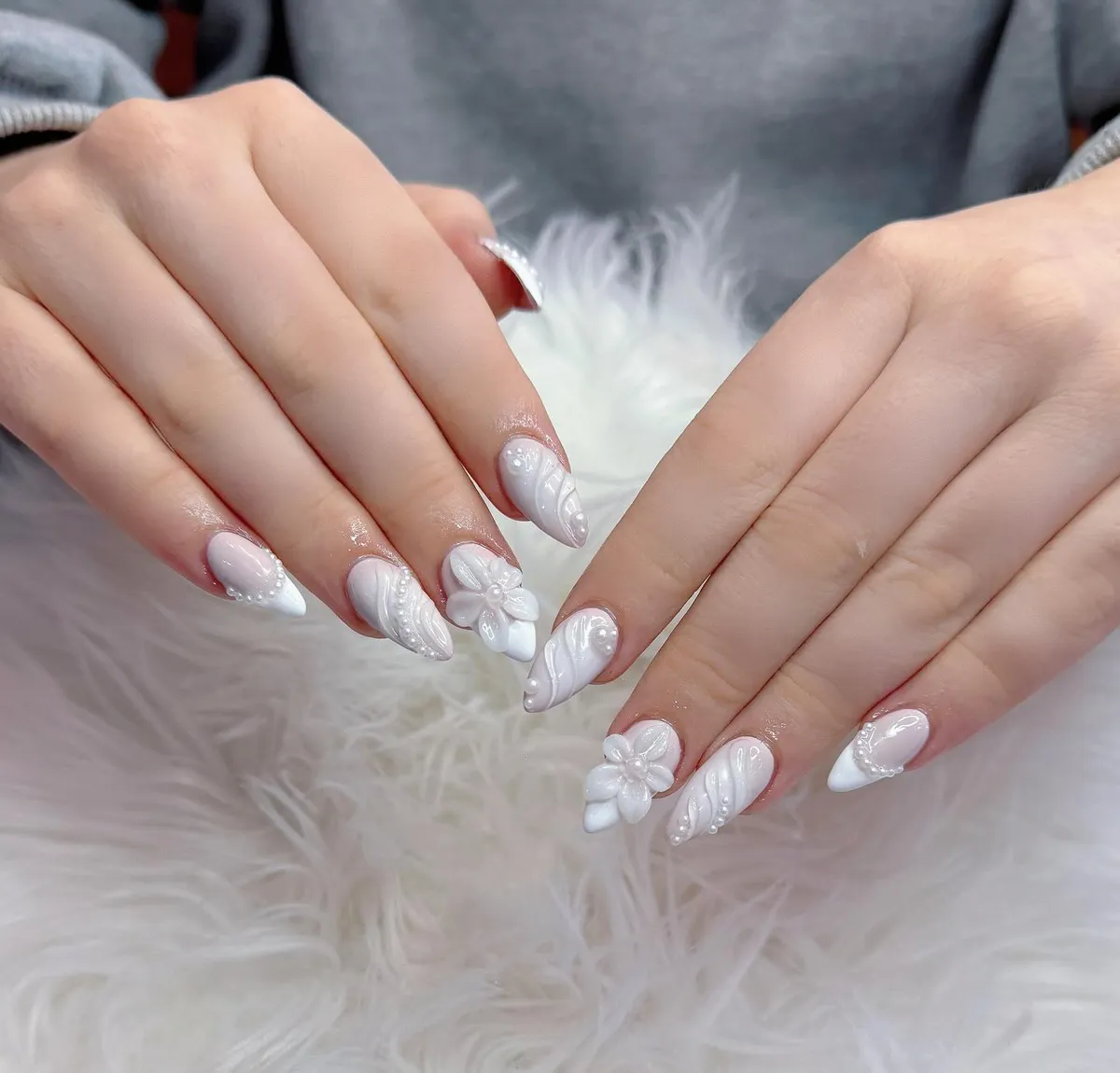 All-white textured almond nails with pearls and 3D flowers