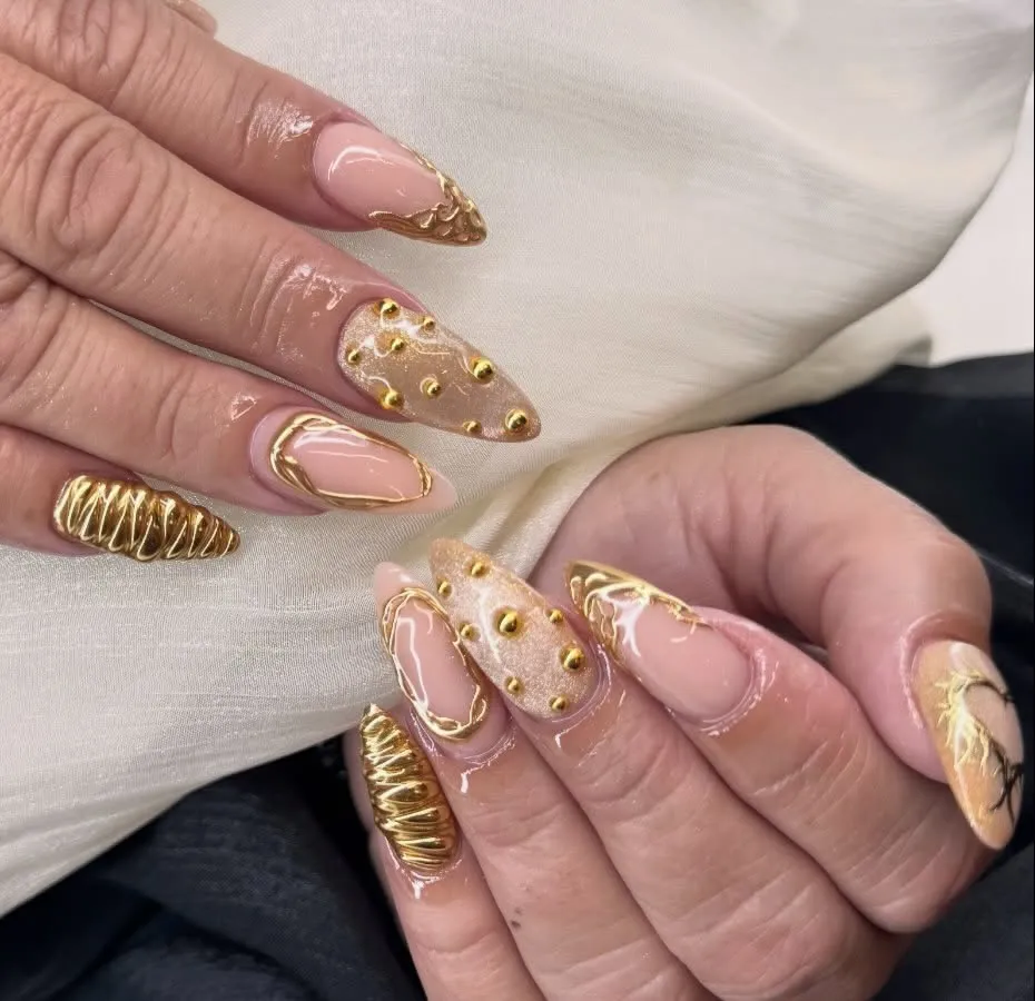 Gold outline frames with studded glitter accents and a ribbed gold statement nail