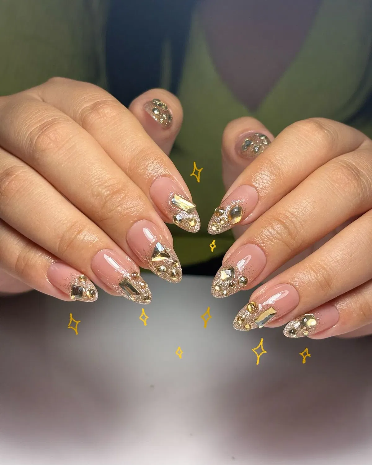Glitter-tipped nude almonds with mixed-shape gem accents