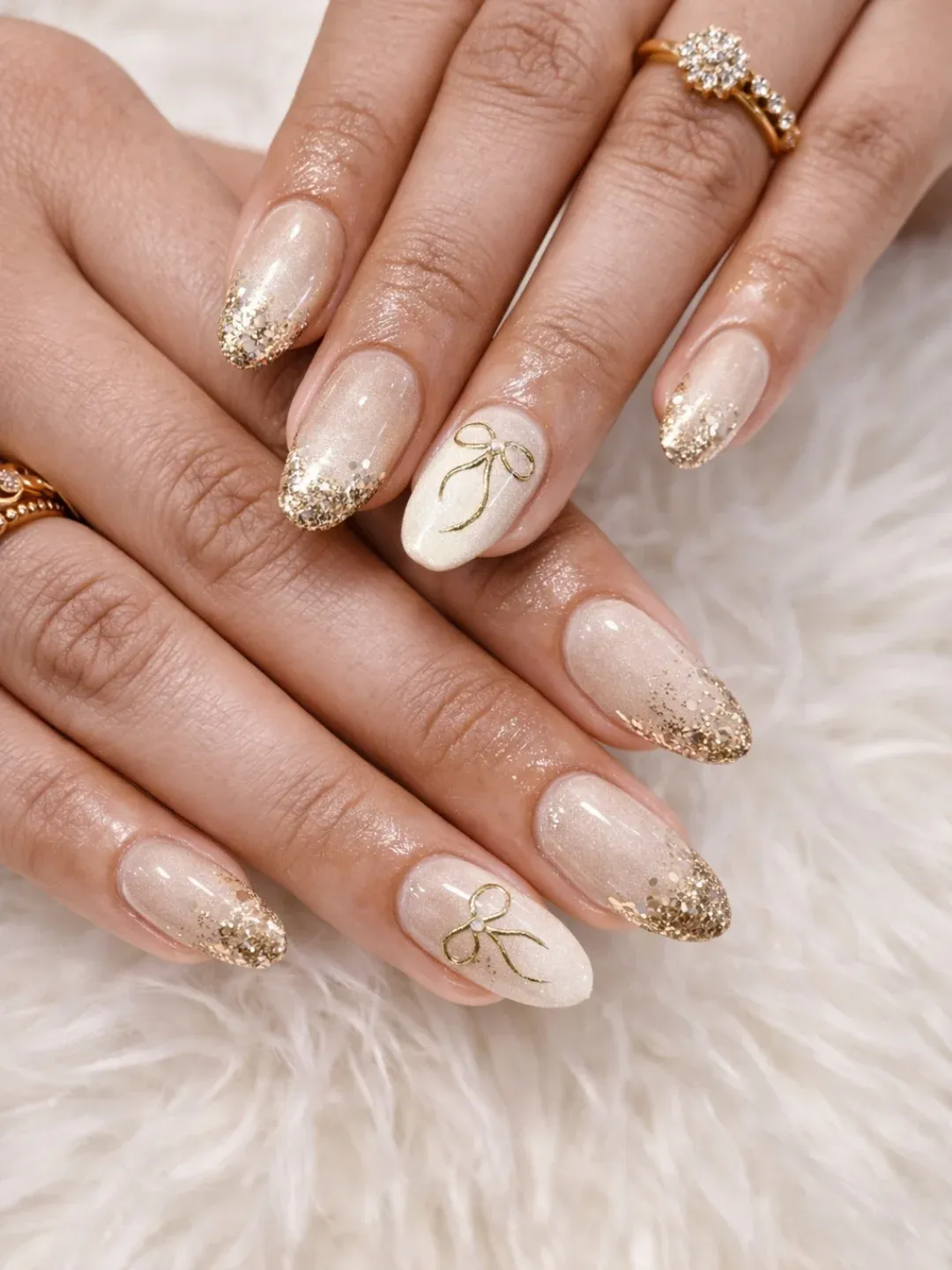 Gold glitter tips with bow outline accents