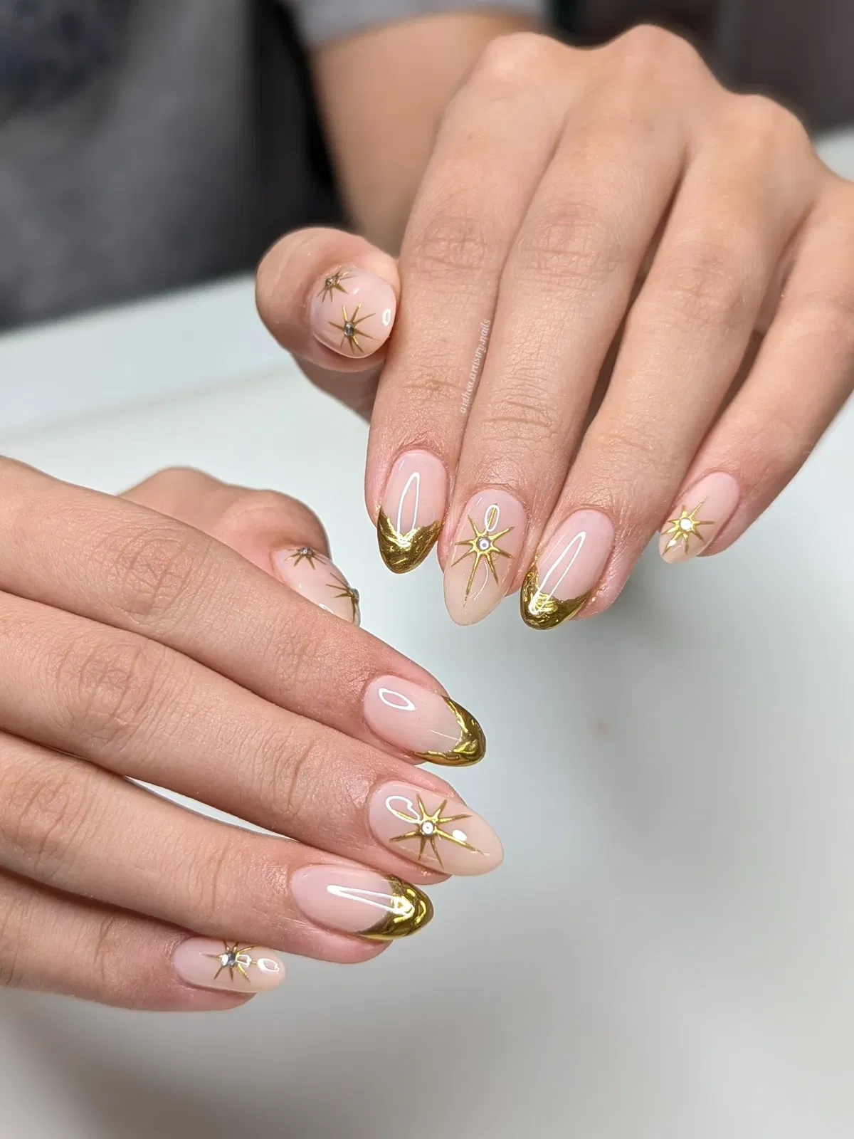 Gold crescent French tips with starburst accents