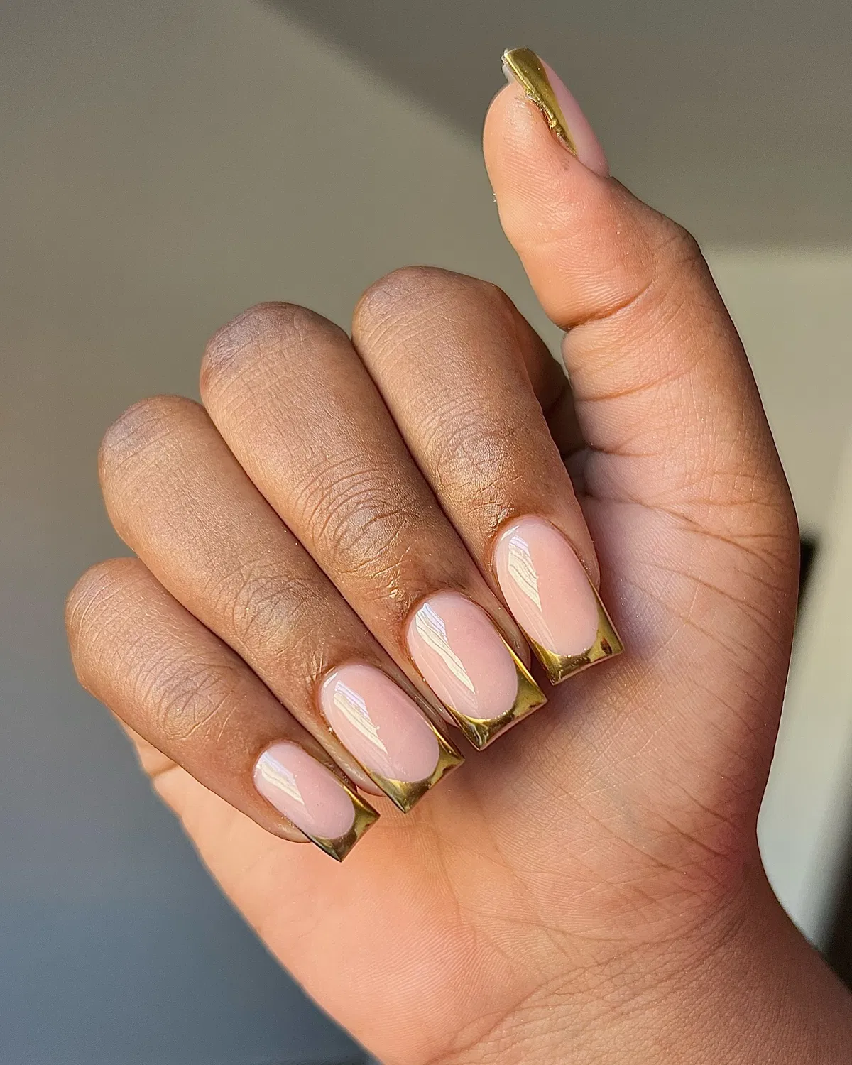 Pale pink base with metallic-gold square French tips
