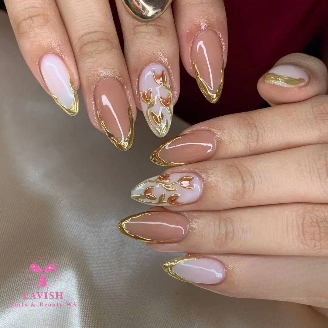 Gold-outlined French with leaf-pattern accent nails