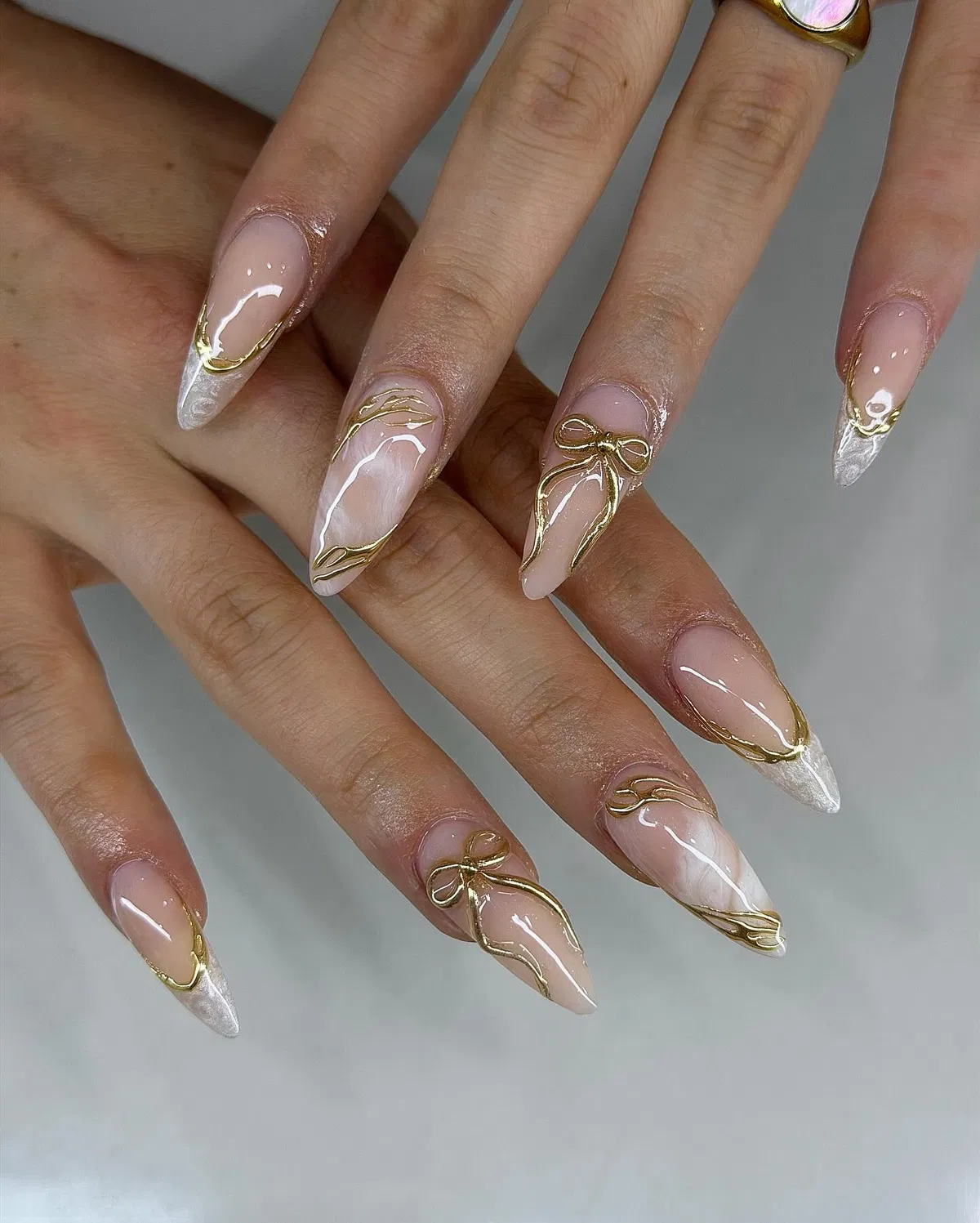 Stiletto French with Gold Outlines and Raised Bow Details