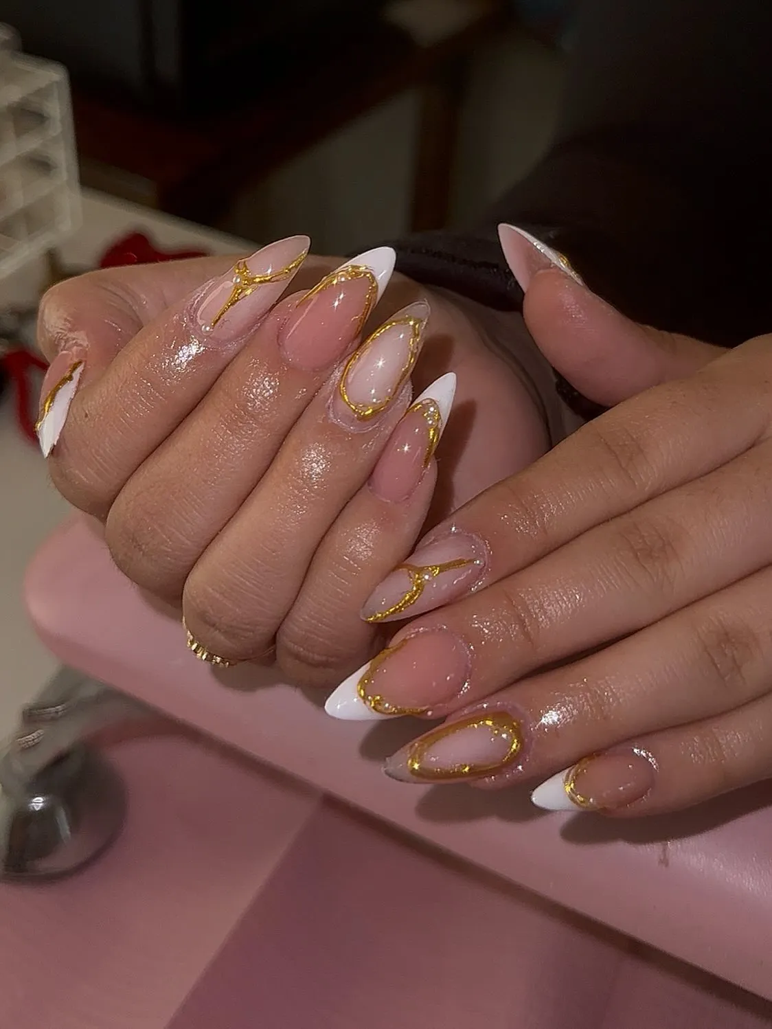 Gold-glitter outlined French with curved framing lines