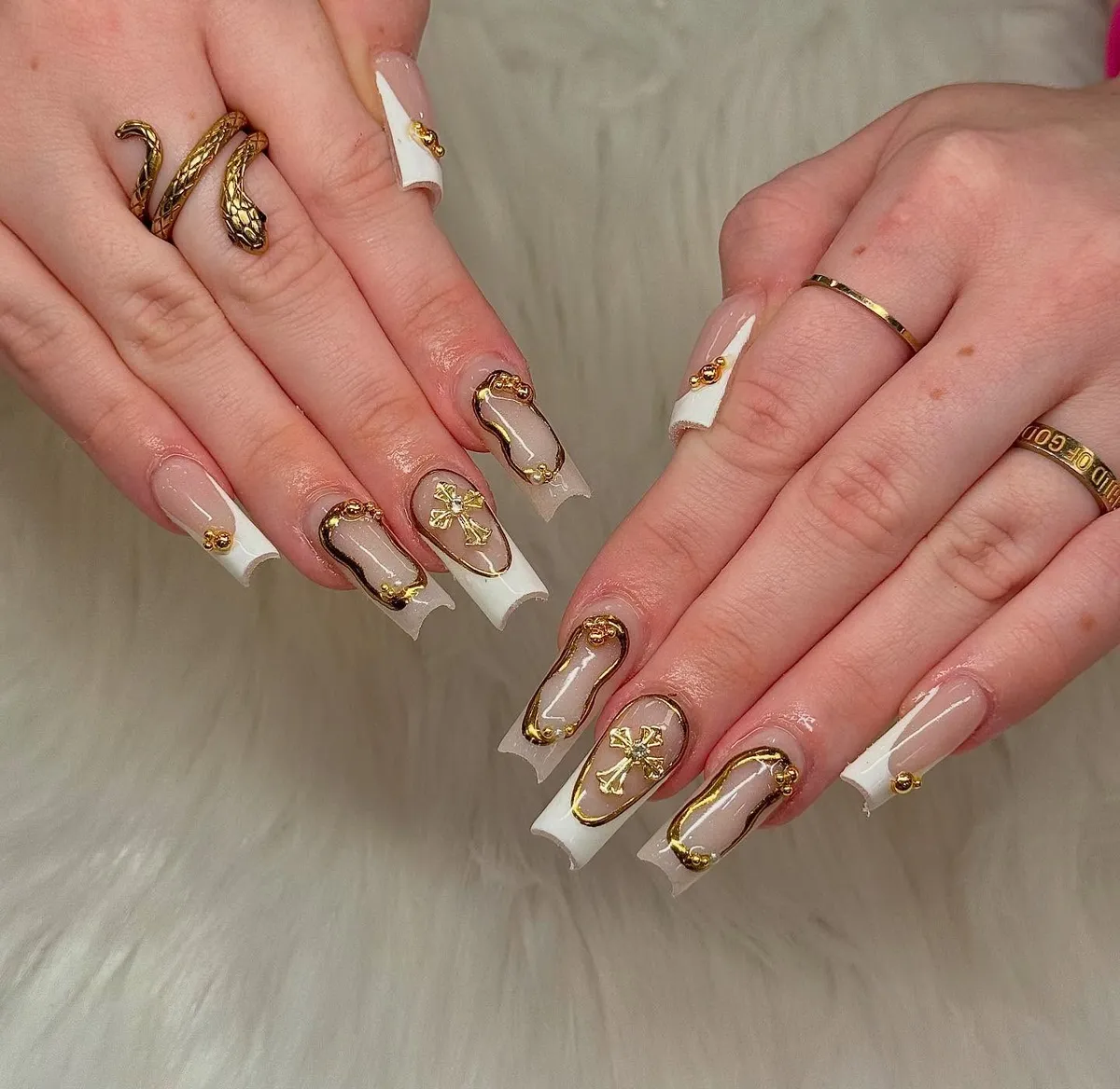 Framed French tips with raised gold borders and cross charms