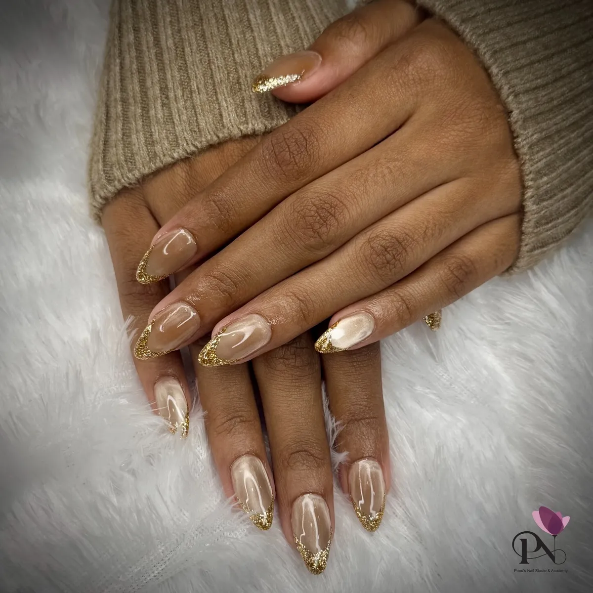 Nude almond nails with gold glitter French tips