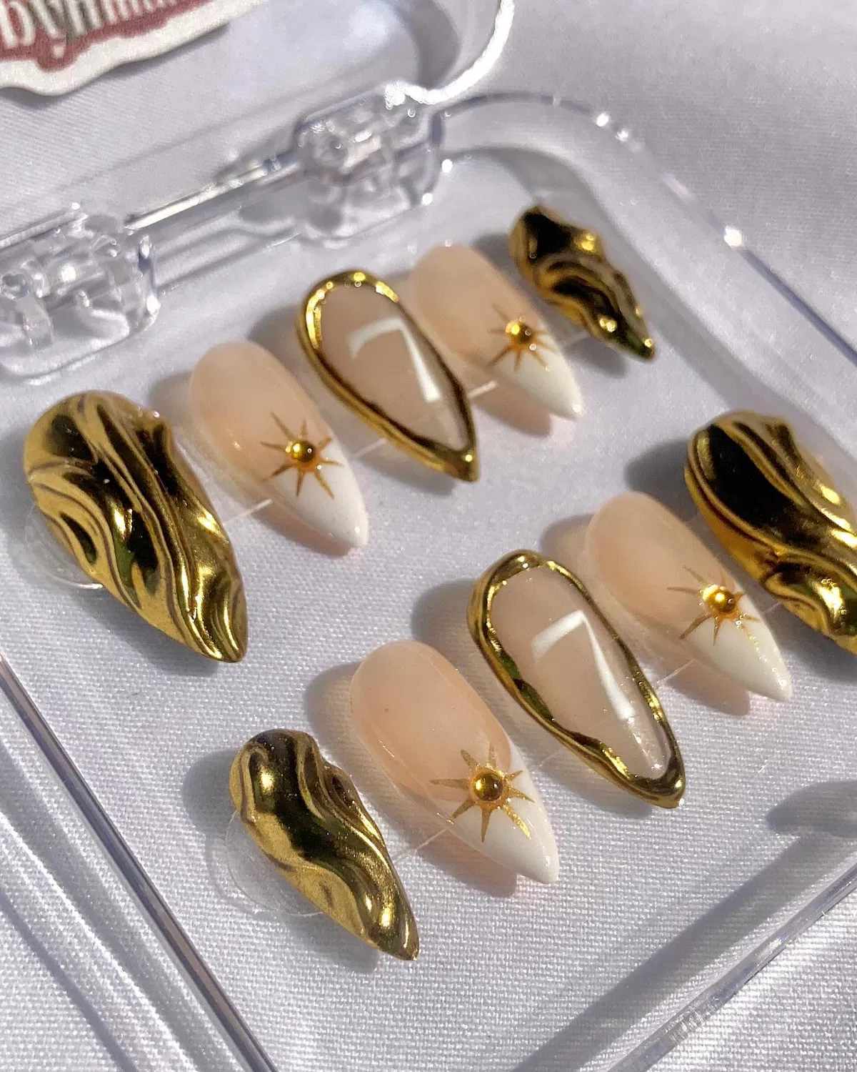 Gold sculpted accents with nude-to-white gradients