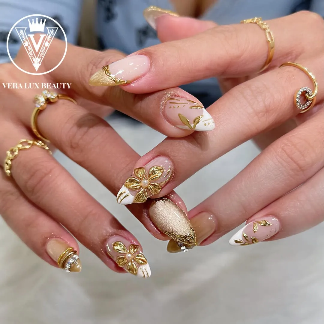 Raised gold florals on nude and white nails