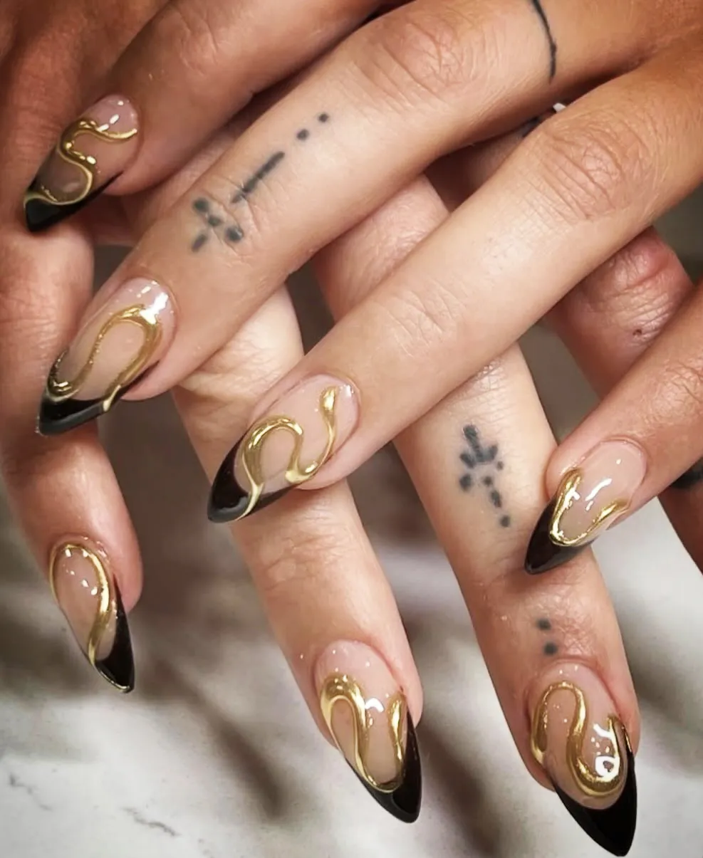 Black French tips with raised gold wave lines