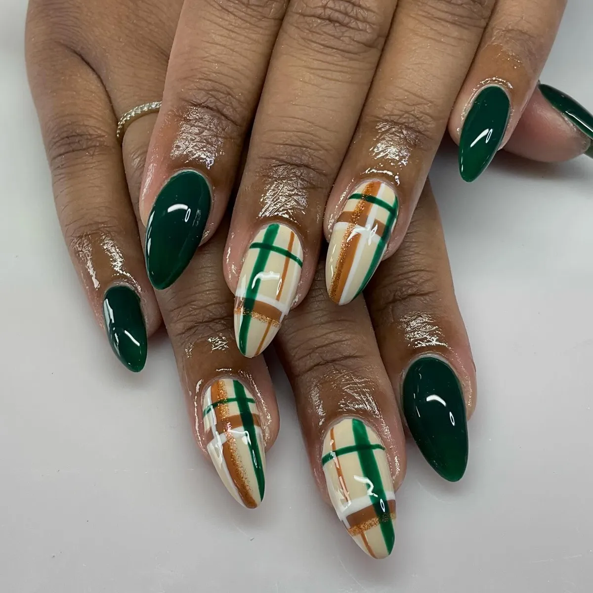 Long deep-green almonds with beige plaid accents and gold striping