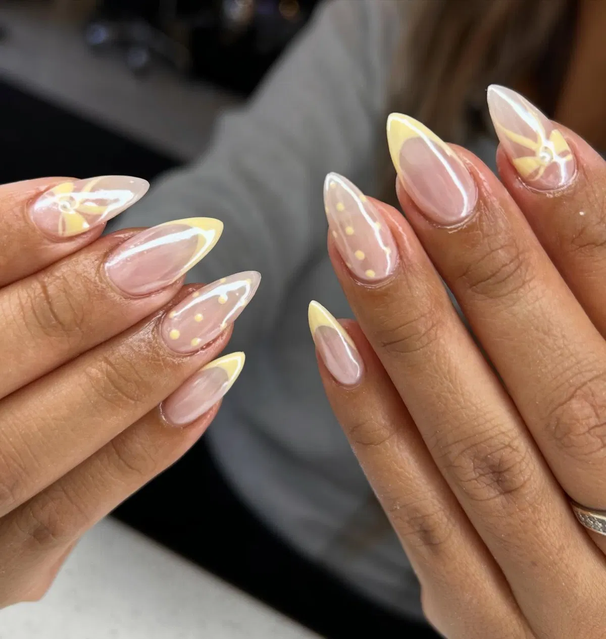 Glossy Nude Base with Light Yellow French Tips and Minimal Dot/Flower Details