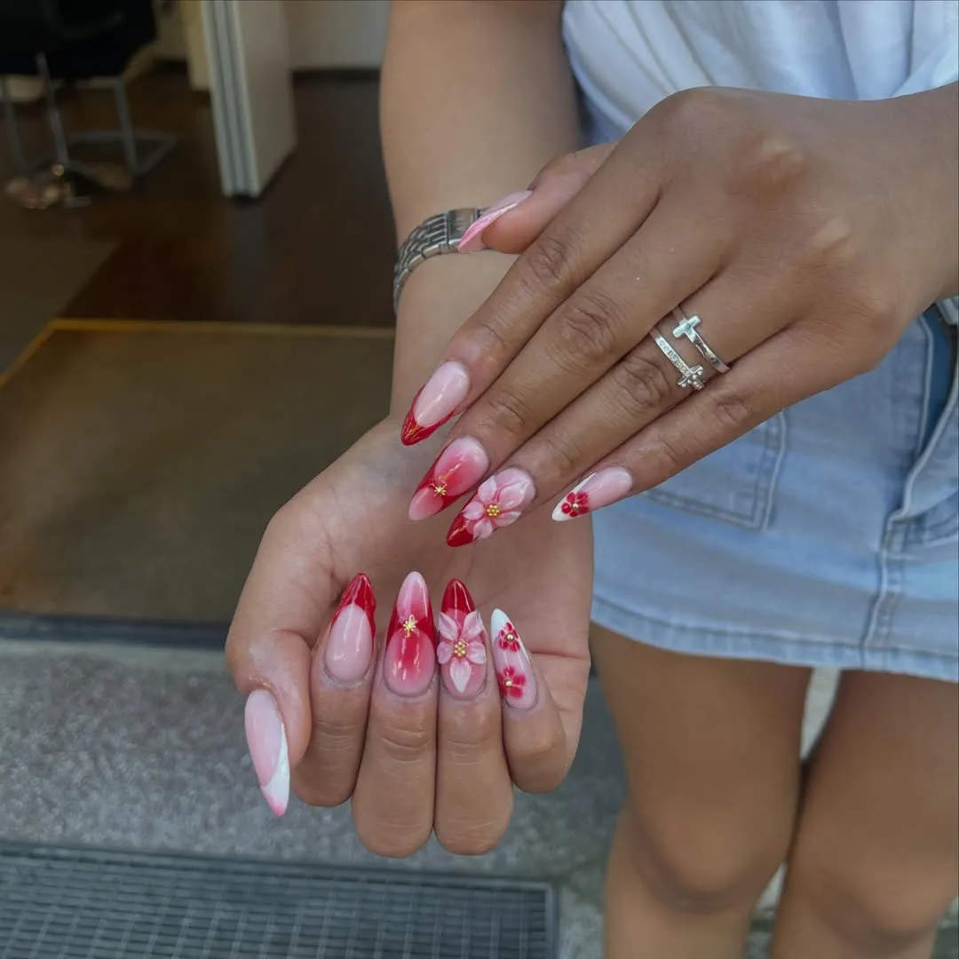 Red-tipped florals with nude base and small gold accents