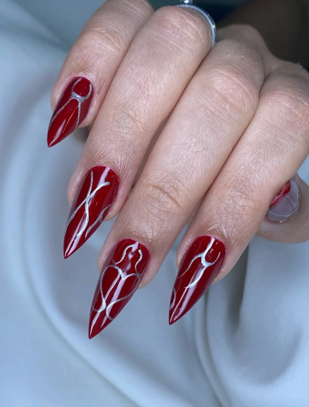 Deep red stilettos with abstract silver line art