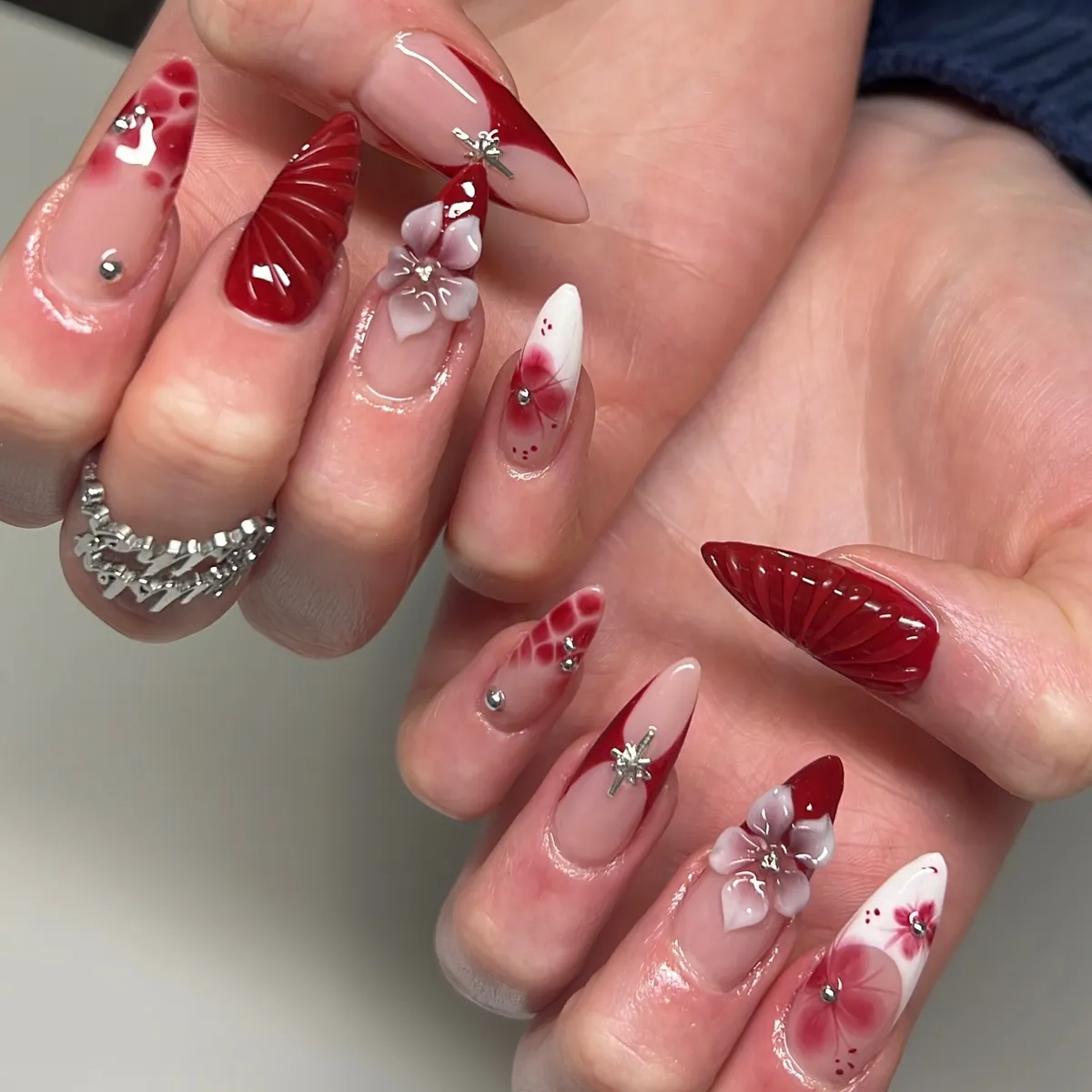 3D florals, cross charms, and textured deep-red accents