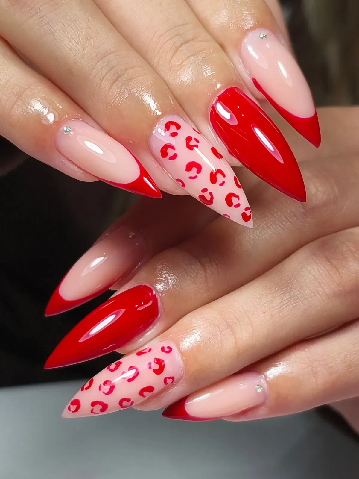 Red French tips with leopard accent and rhinestones