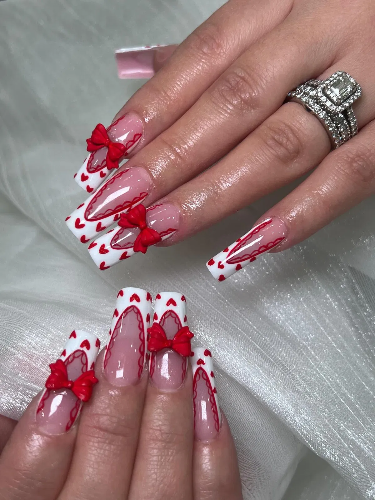 White-tipped hearts with red bow embellishments