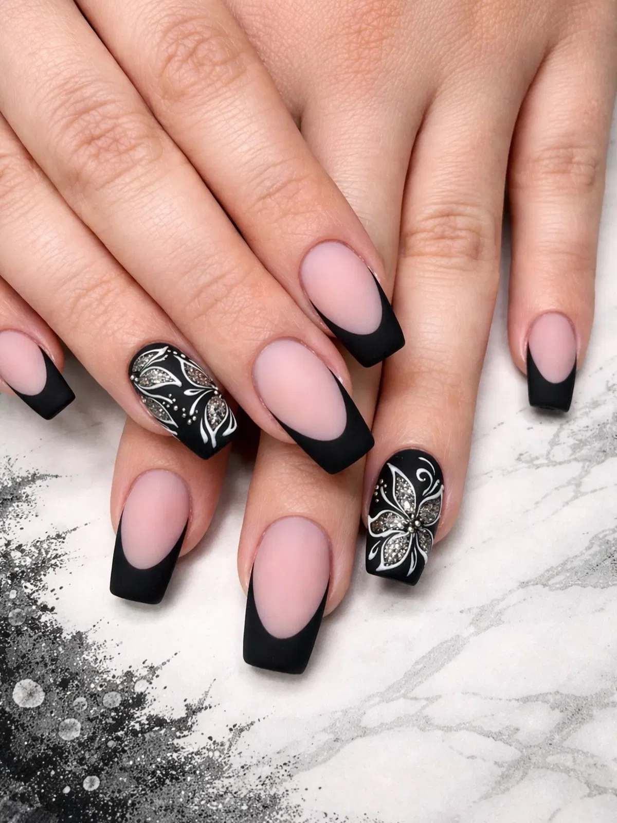 Matte black French tips with floral glitter accents