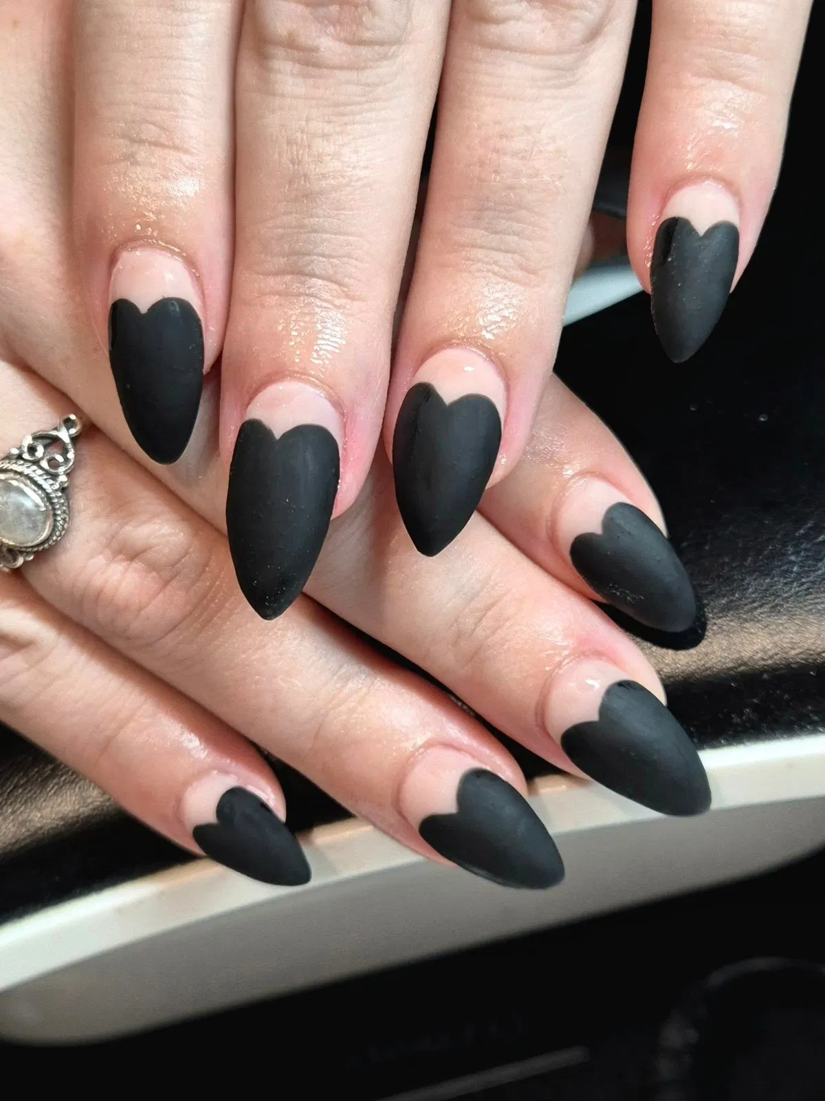 Matte black scalloped French tips over nude base
