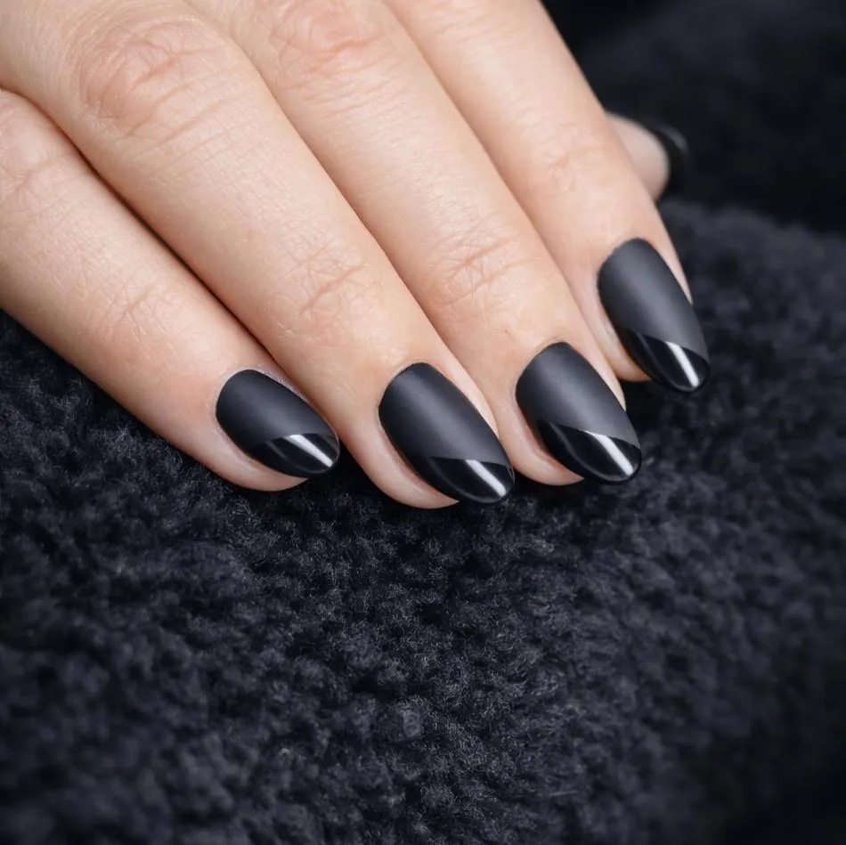 Matte black nails with glossy diagonal tip stripes