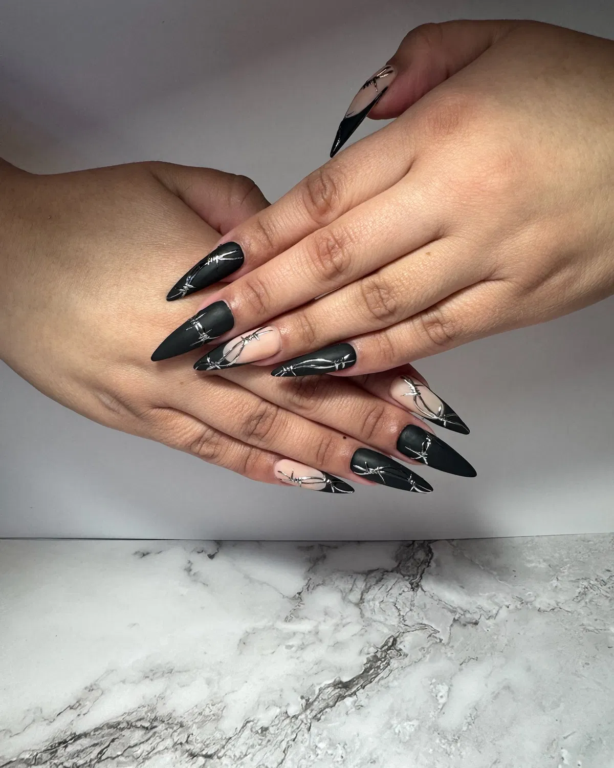 Matte stiletto nails with silver barbed-wire-style lines