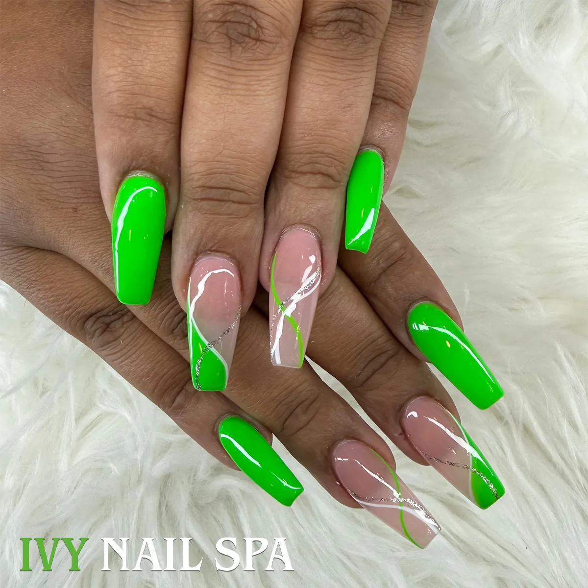 Neon green coffin nails with nude diagonals and silver glitter lines