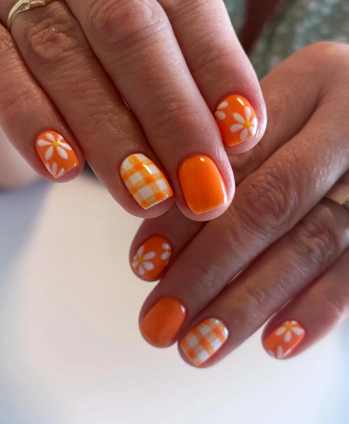 Orange solids with daisy florals and orange-white check