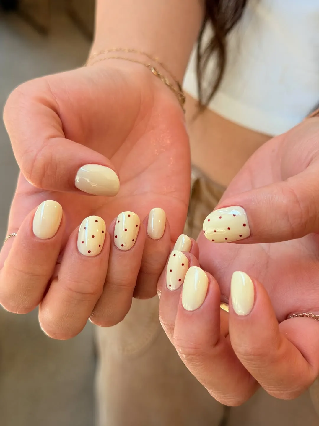 Pale creamy yellow with small red dot accents