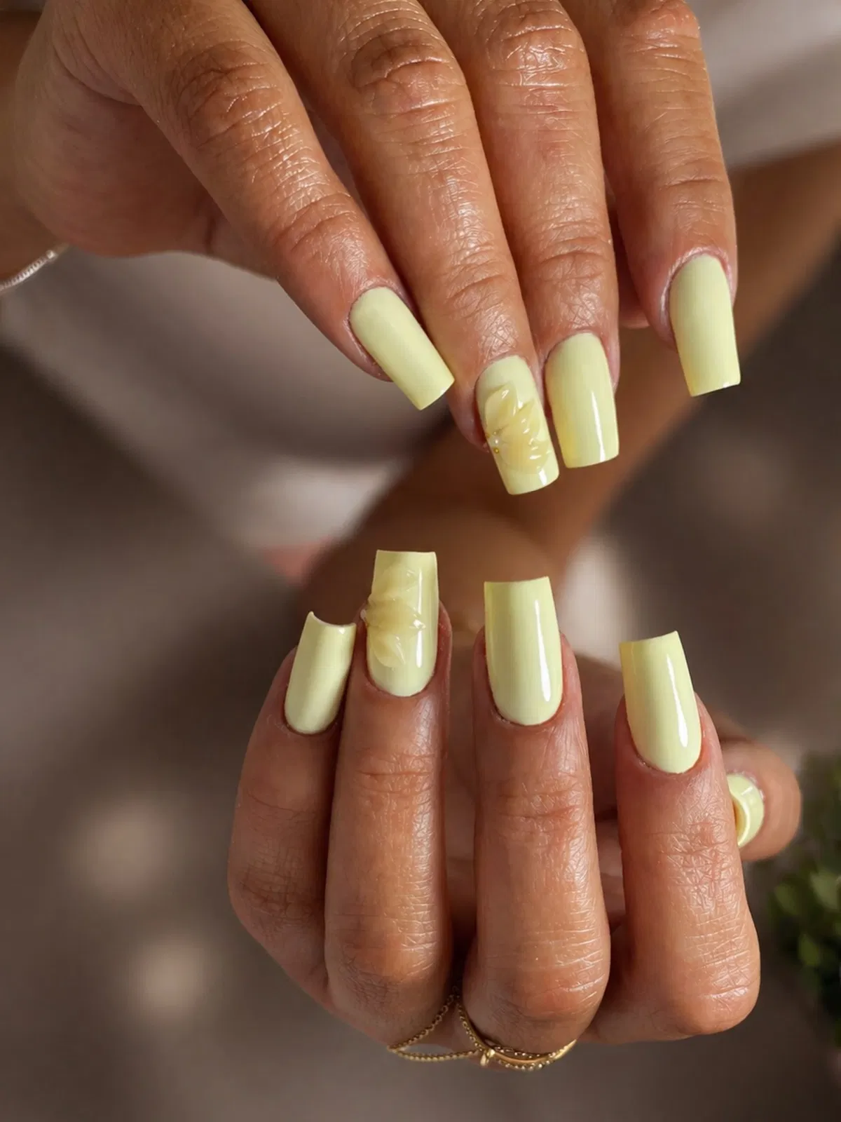 Long glossy pale yellow with subtle raised floral accents