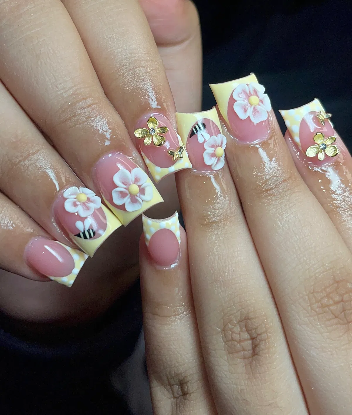Pastel yellow French tips with 3D florals and gold charms