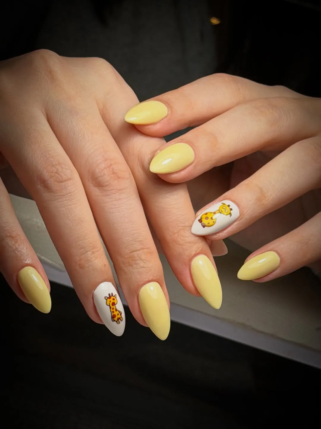 Solid pastel yellow with giraffe accent nails