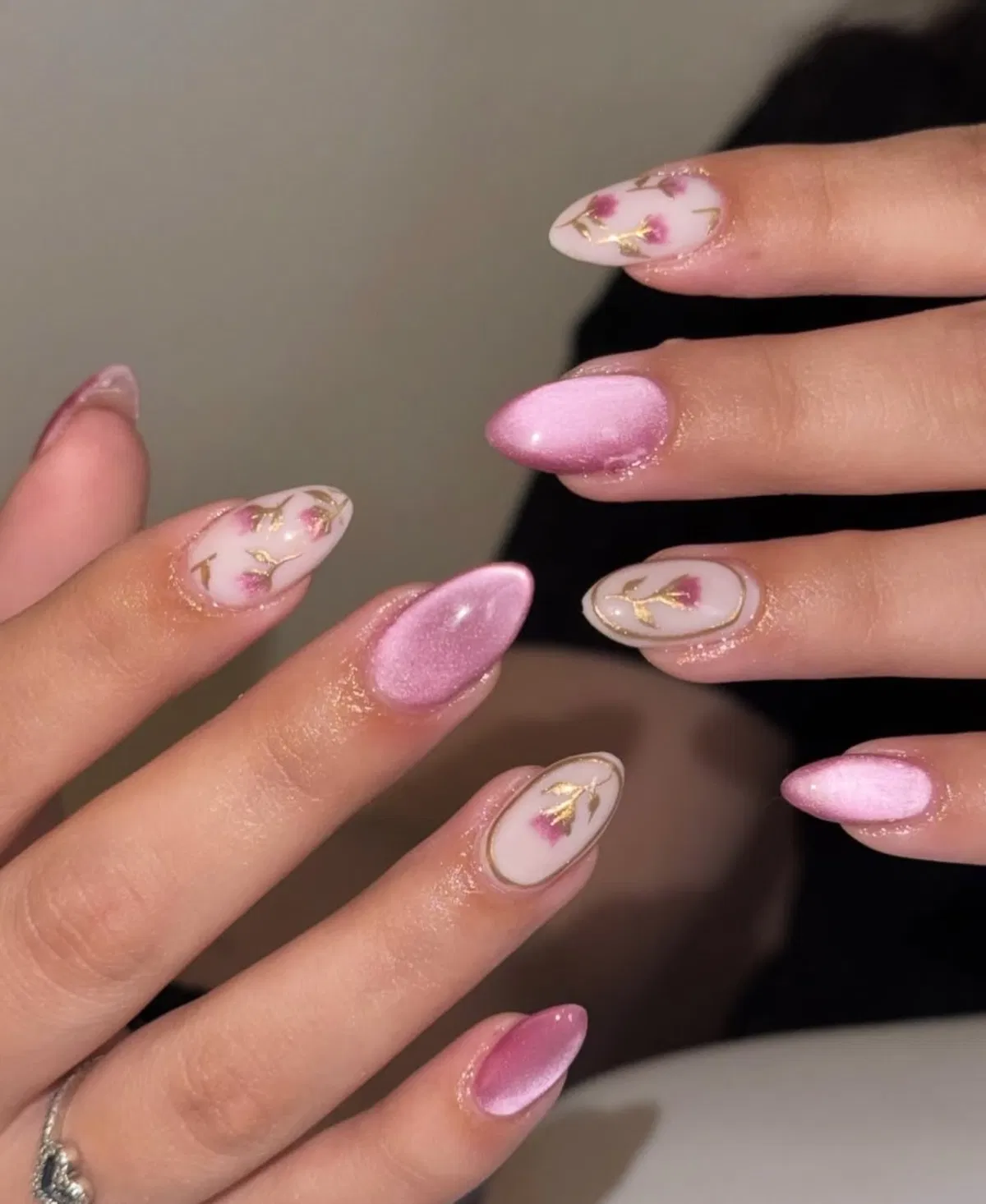 Pearly pink nails paired with gold-lined floral accents