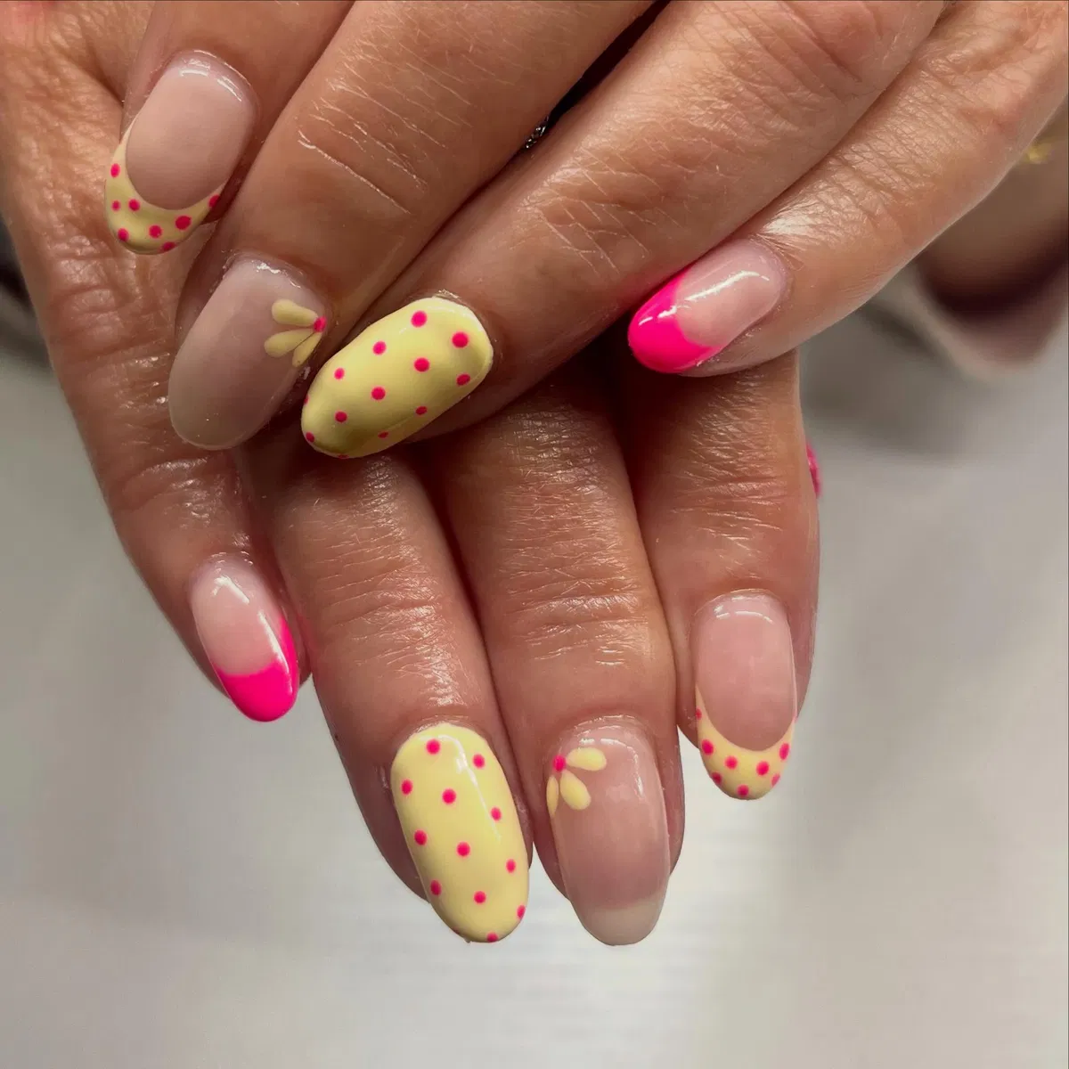 Polka-dot yellow accents with hot pink French tip