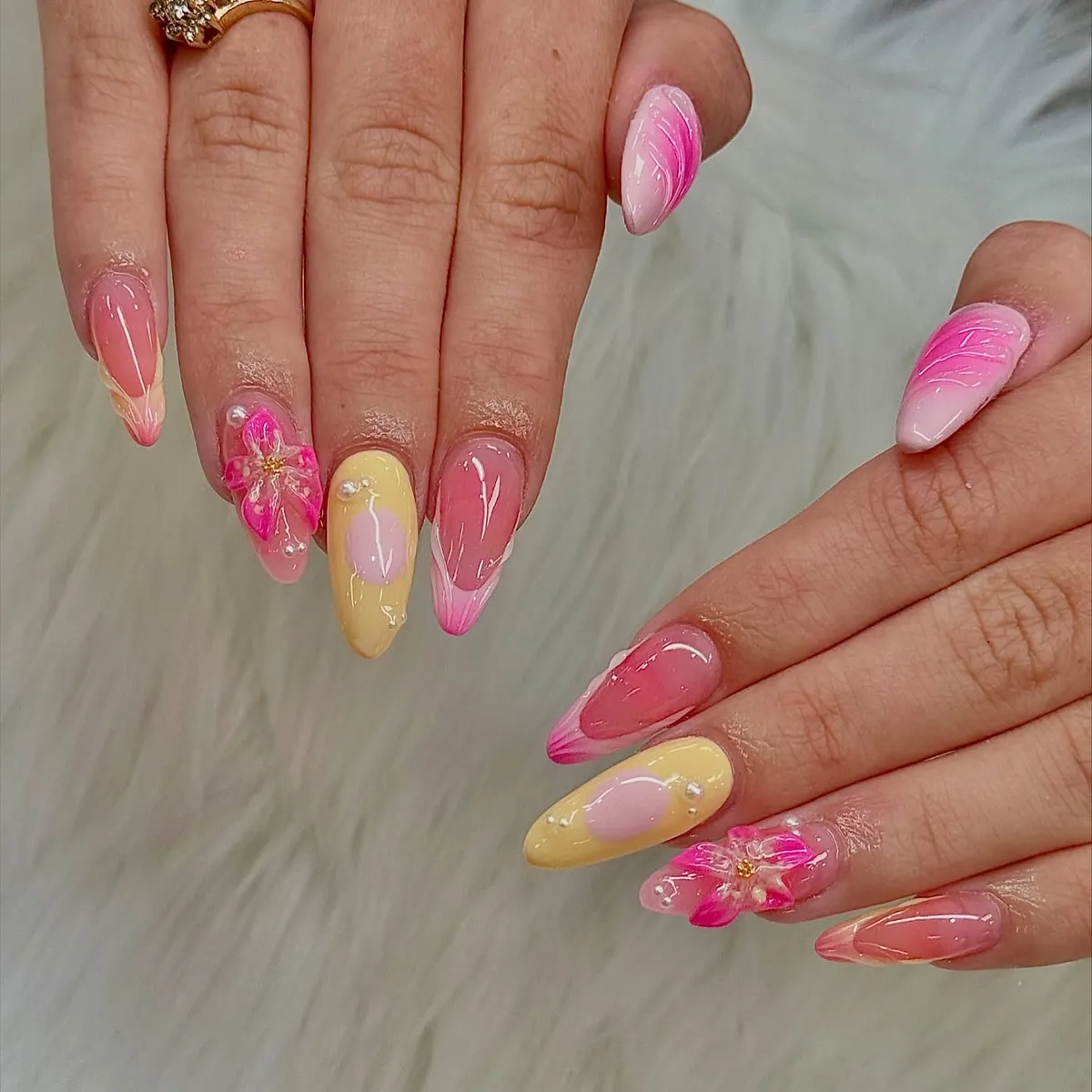 Almond nails with pink/yellow mix and 3D floral accents