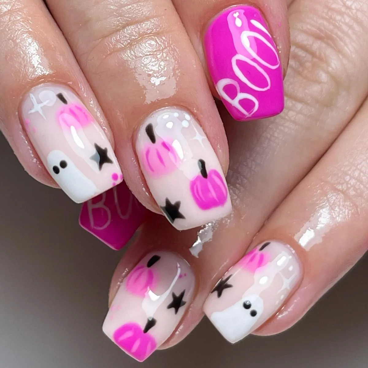 Bright pink βBOOβ nail with pumpkins, ghosts, and stars