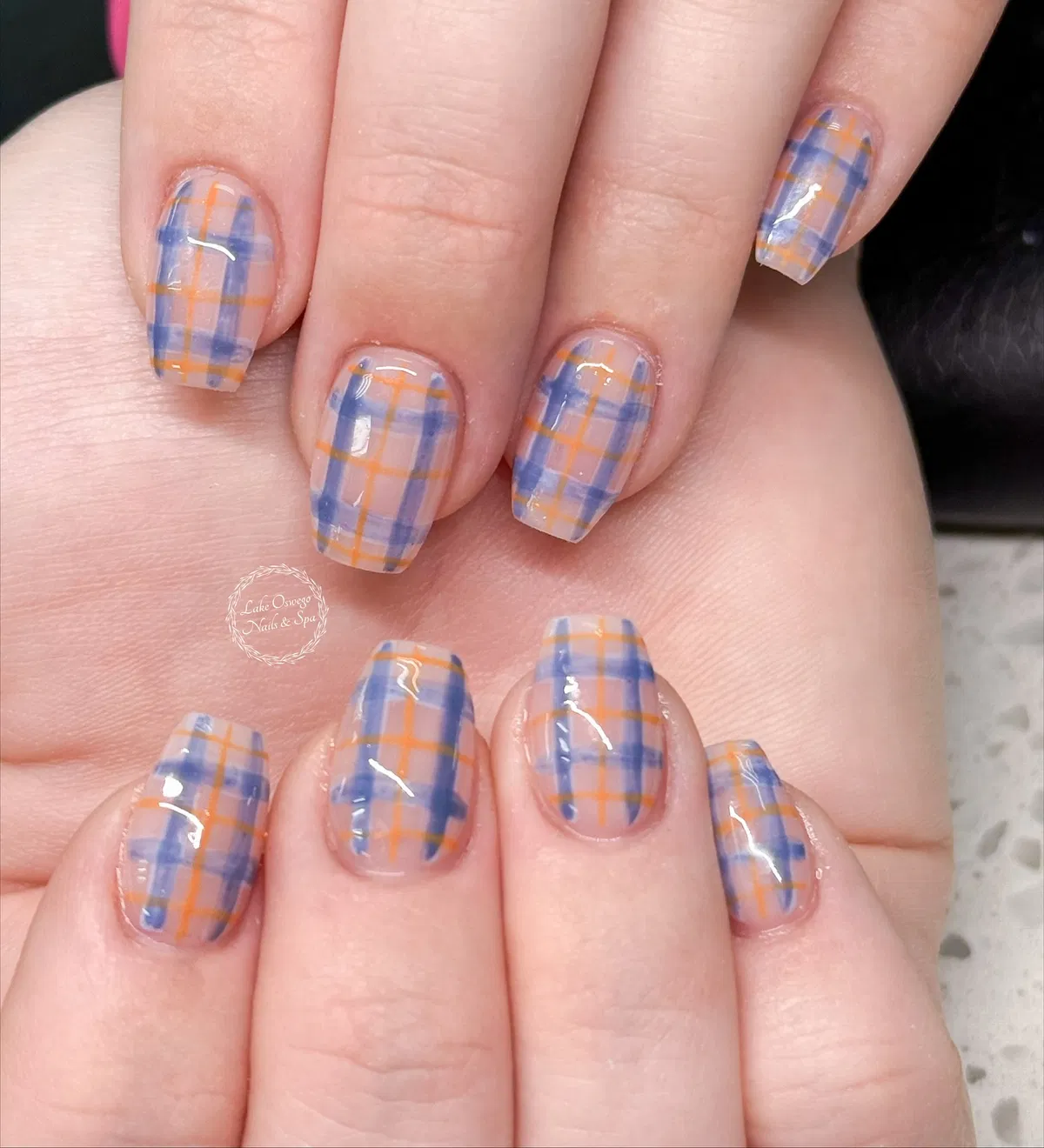 Sheer nude base with blue-and-orange plaid grid