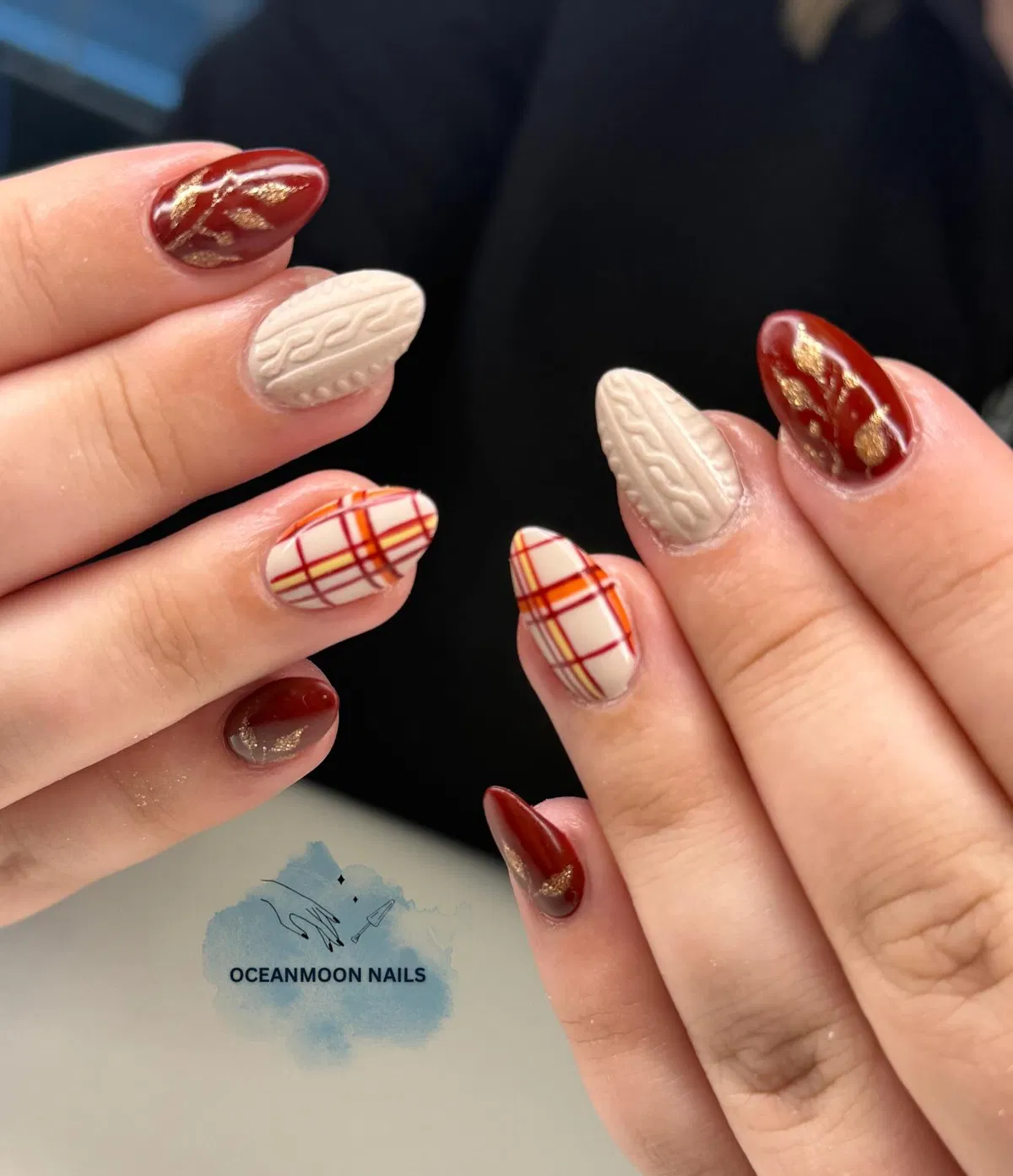 Cream knit texture with warm plaid and red-gold accents
