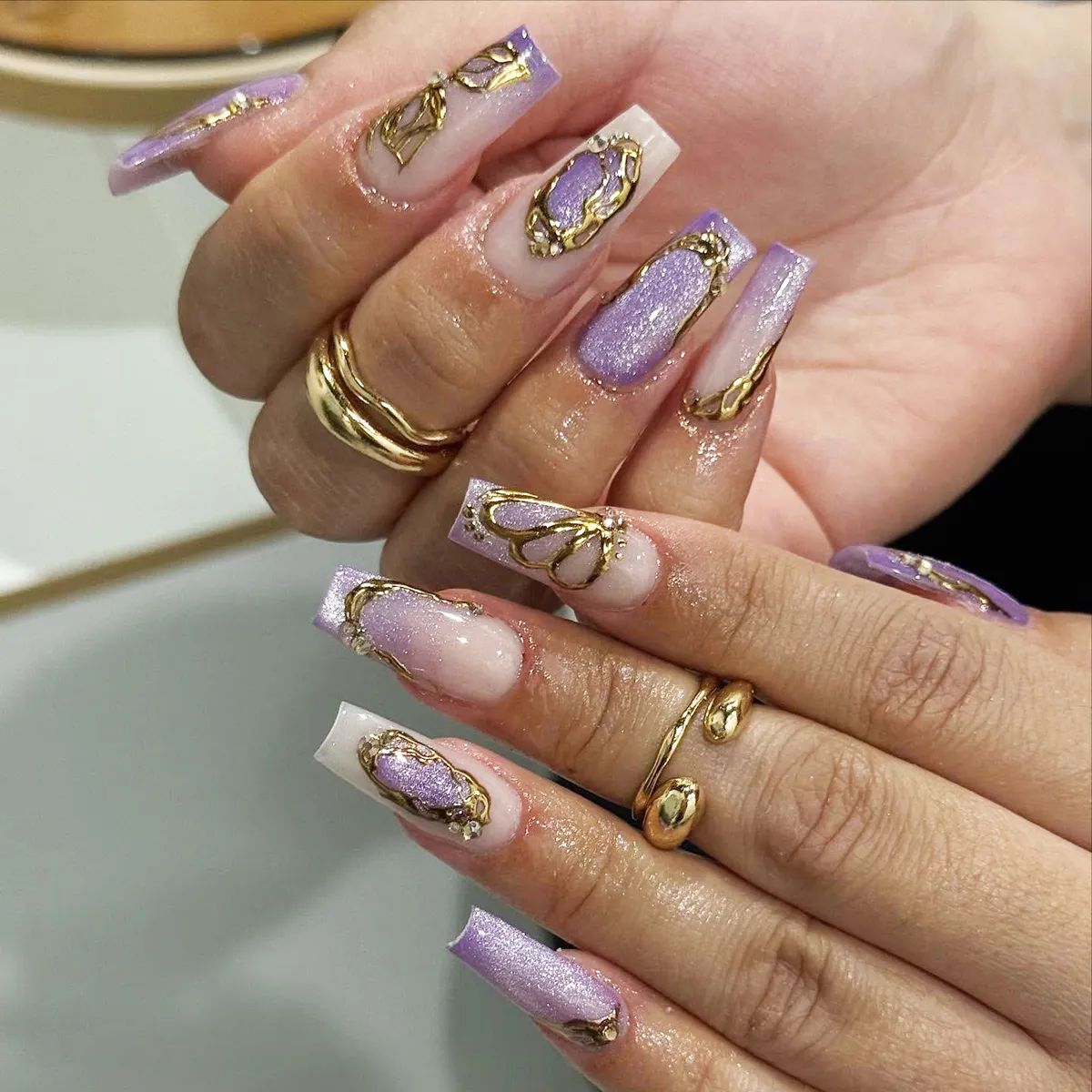 Lavender shimmer coffin nails with raised gold framing details