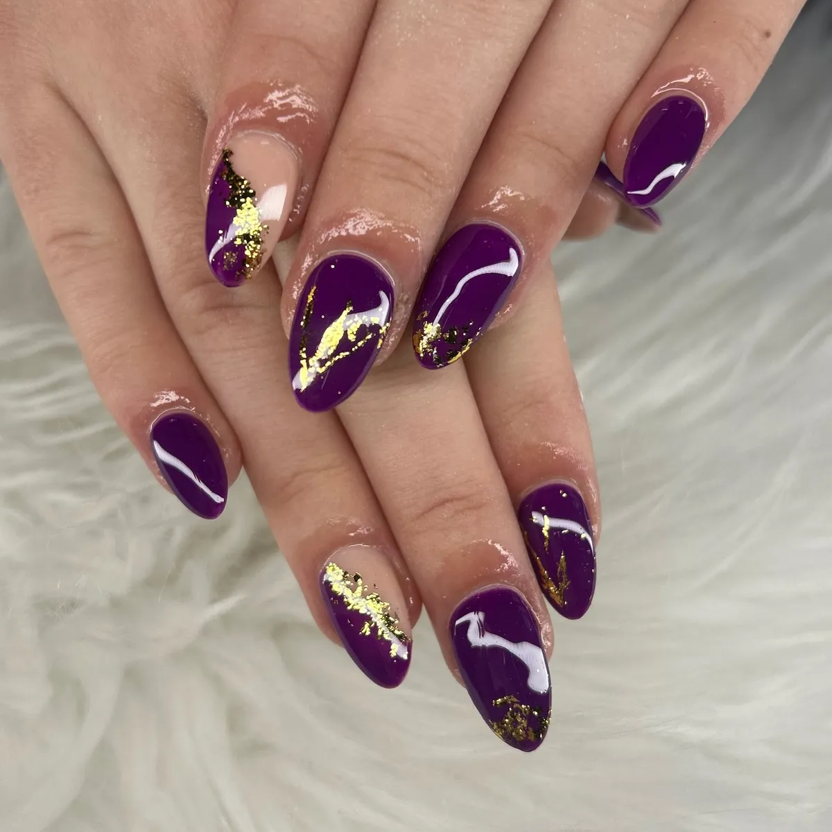 Deep purple glossy nails with scattered gold flecks