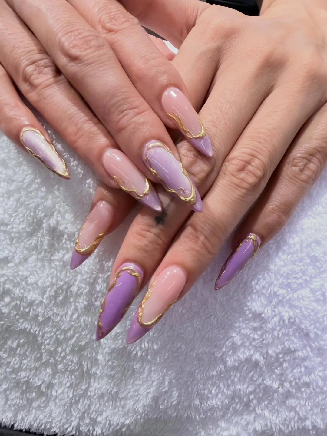 Lavender and nude stiletto nails with thin gold outline borders