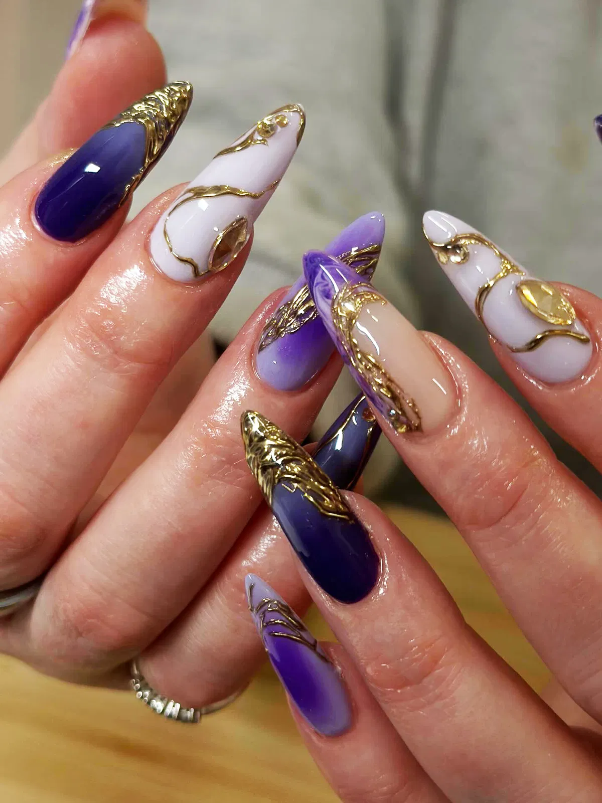 Stiletto mix with raised gold sculpting and large oval gem settings