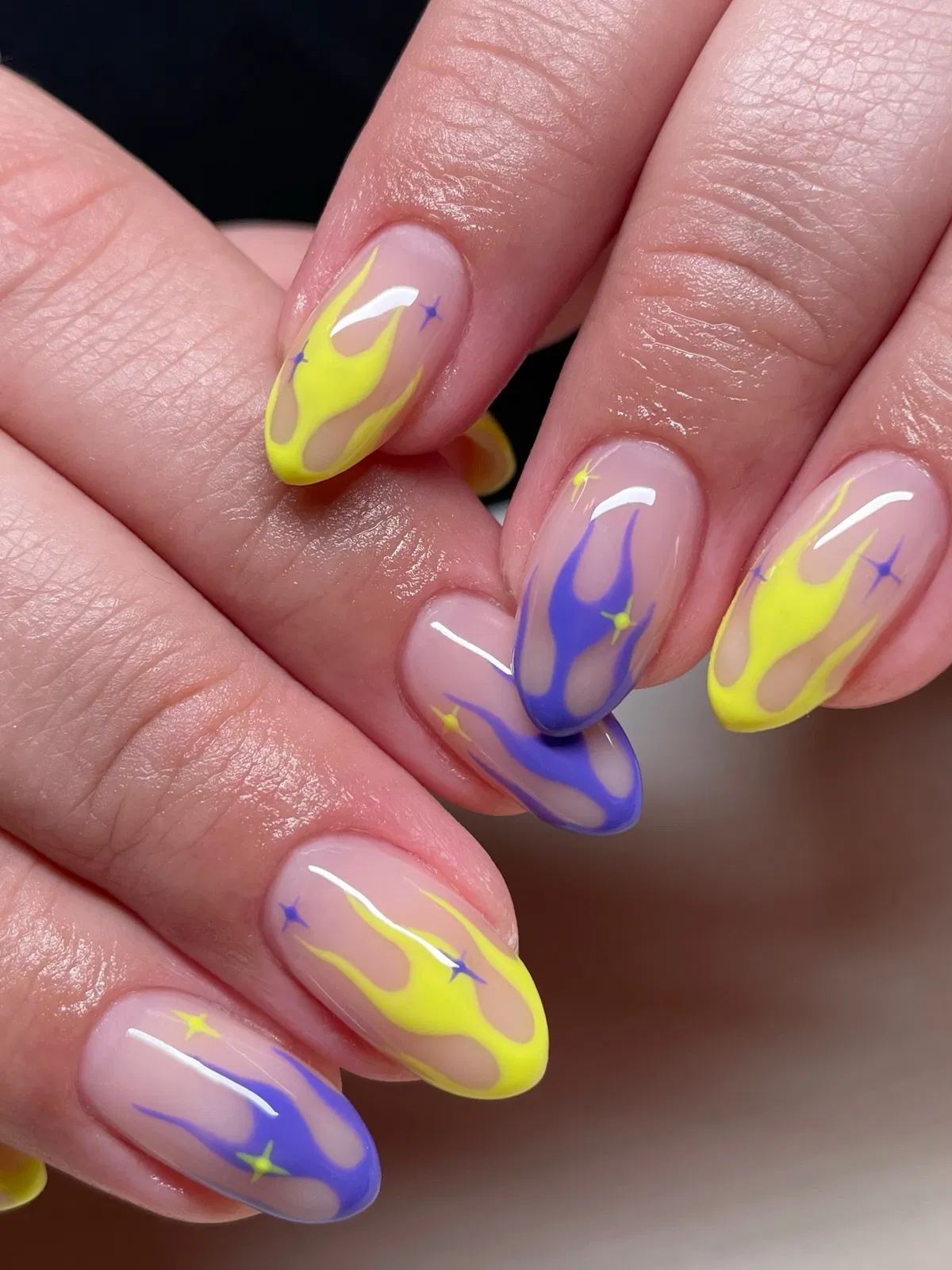 Neon yellow and purple flame accents on nude base