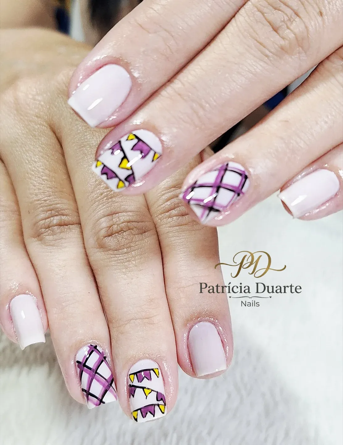 Soft pink base with purple plaid and geometric triangle accents