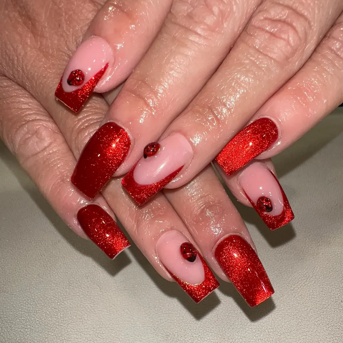 Red glitter square nails with ladybug accents