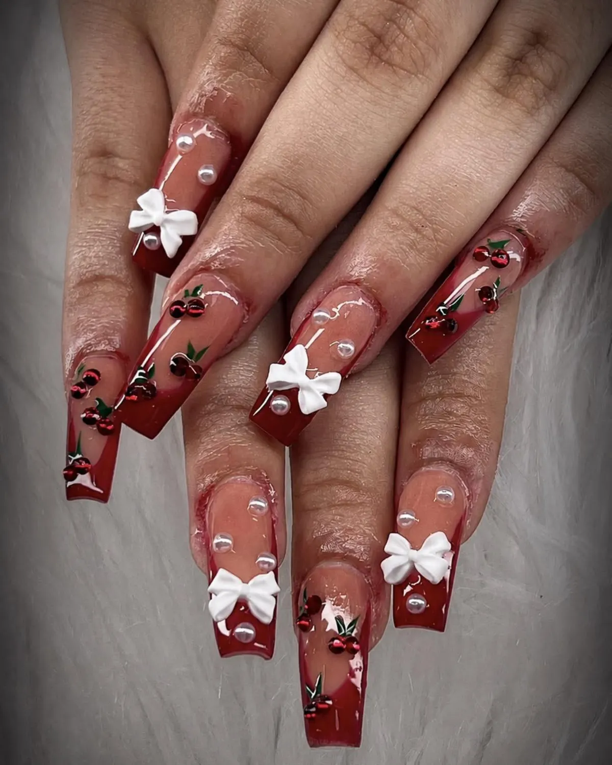 Cherry-and-bow red coffin nails with pearl accents