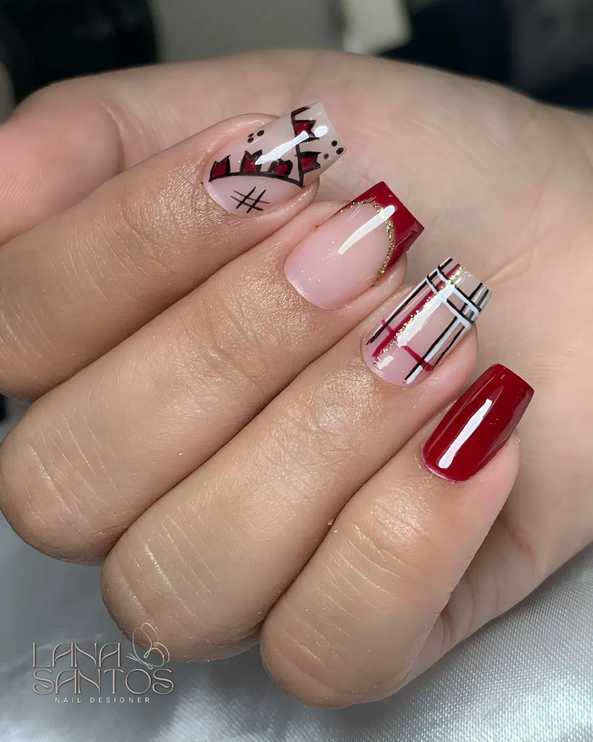 Deep red with nude French tips and plaid accent lines