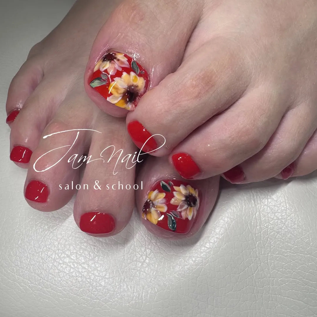 Bright red toes with floral big-toe art