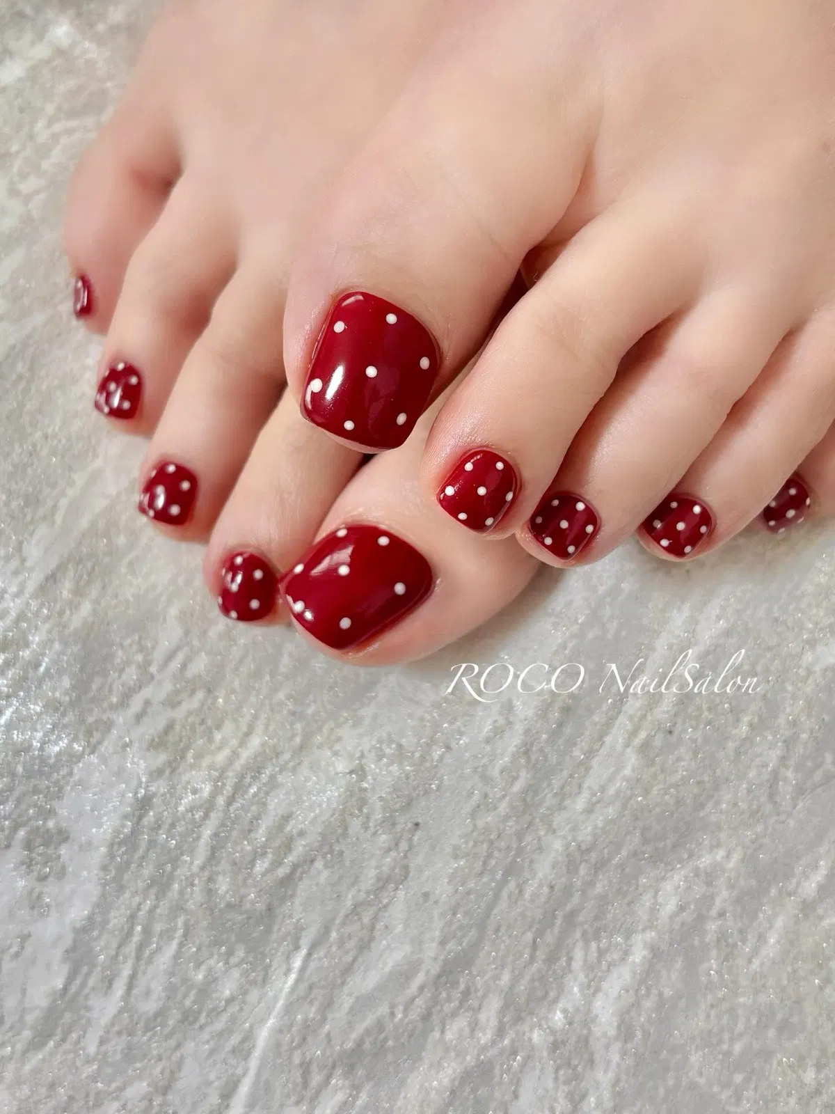 Red pedicure with white polka dots