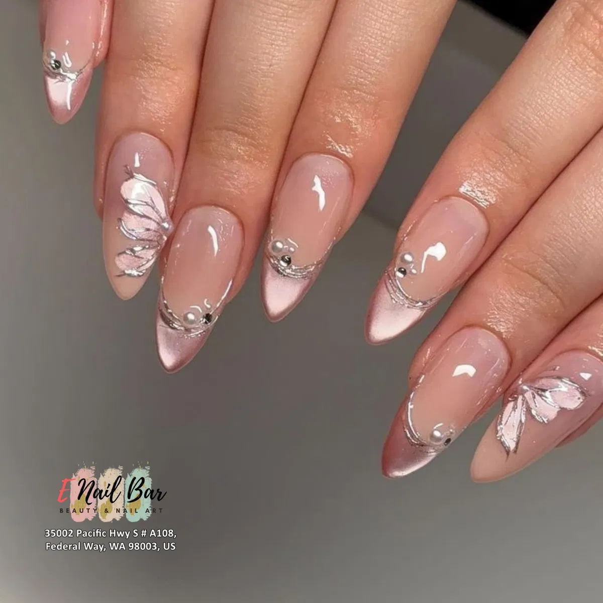 Metallic pink French tips with silver linework and small gem accents